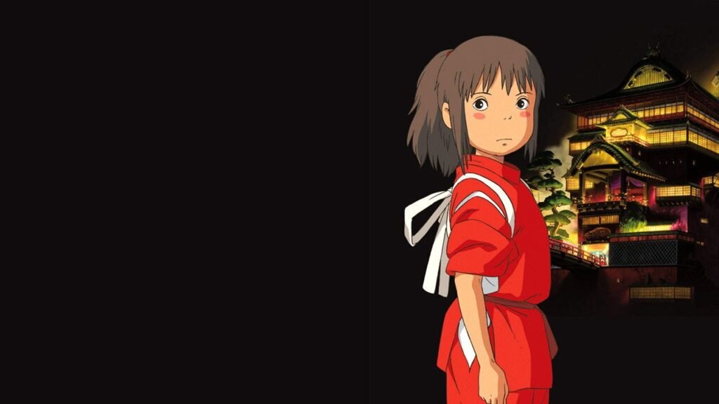 Chihiro de uniforme vermelho diante da casa de banhos iluminada em A Viagem de Chihiro