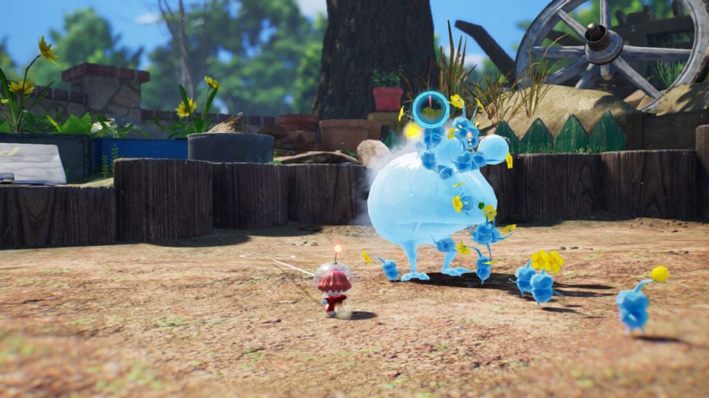 Pikmin azuis atacam uma criatura translúcida num quintal com tocos de madeira e flores, enquanto um explorador de capacete observa, em captura oficial de Pikmin 4