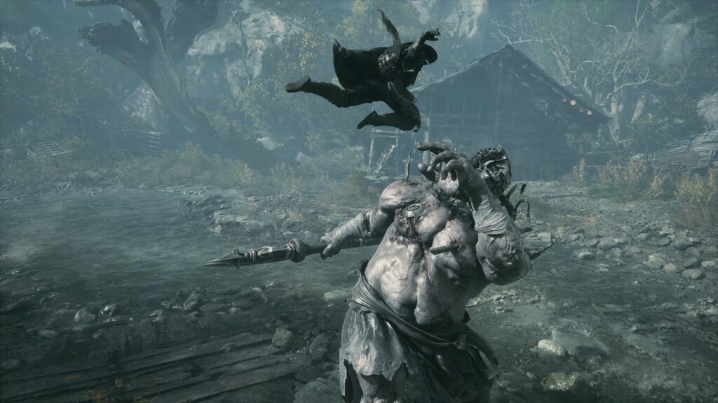 Soul salta no ar sobre um inimigo gigante, musculoso e de pele pálida, armado com uma lâmina, num campo de pedras sob a chuva, em screenshot oficial de Phantom Blade Zero