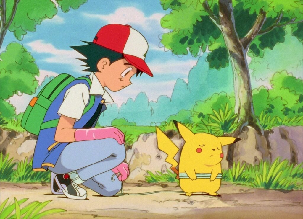 Ash se agacha diante de Pikachu no primeiro episódio do anime Pokémon, "Eu Escolho Você!"