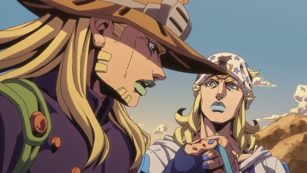 Gyro e Johnny conversam no deserto da 2ª etapa de Steel Ball Run, em cena oficial do anime